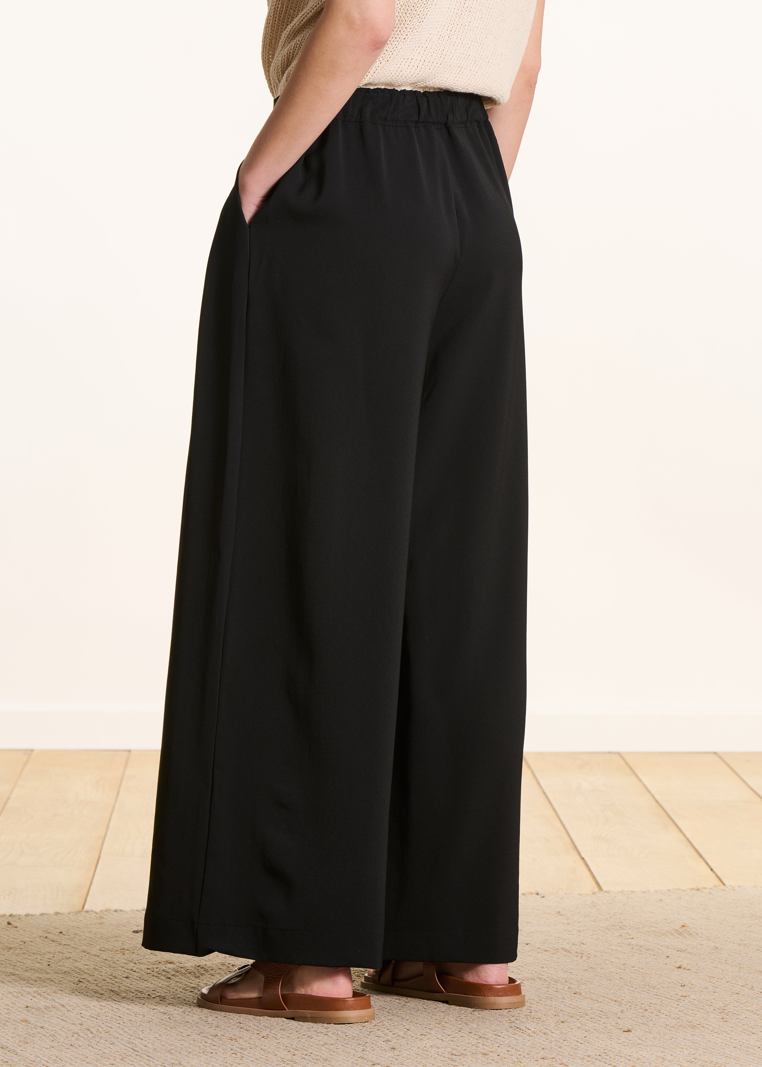 Wide black pleated pants with elastic waist