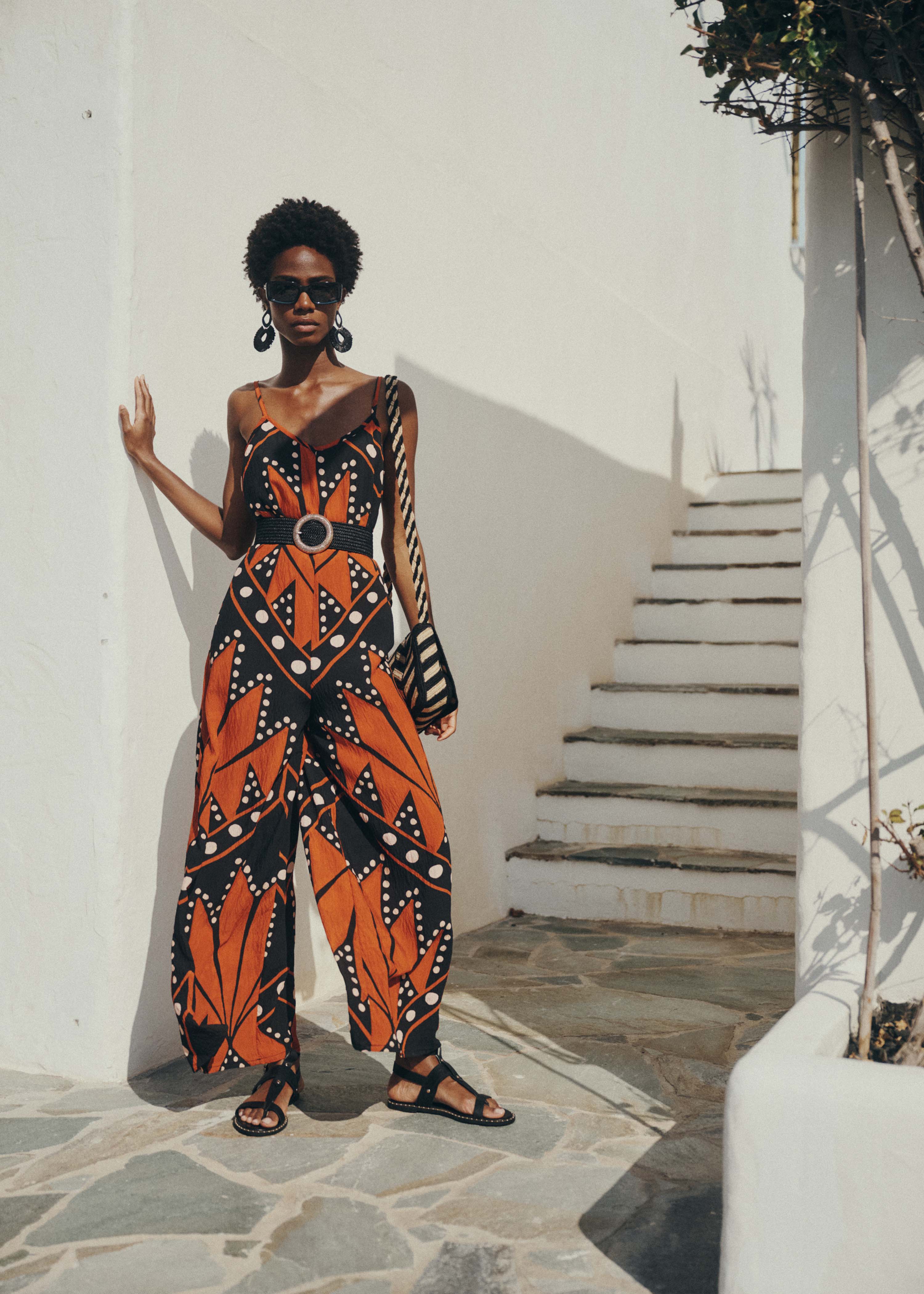 Loose long jumpsuit with straps, black and orange print