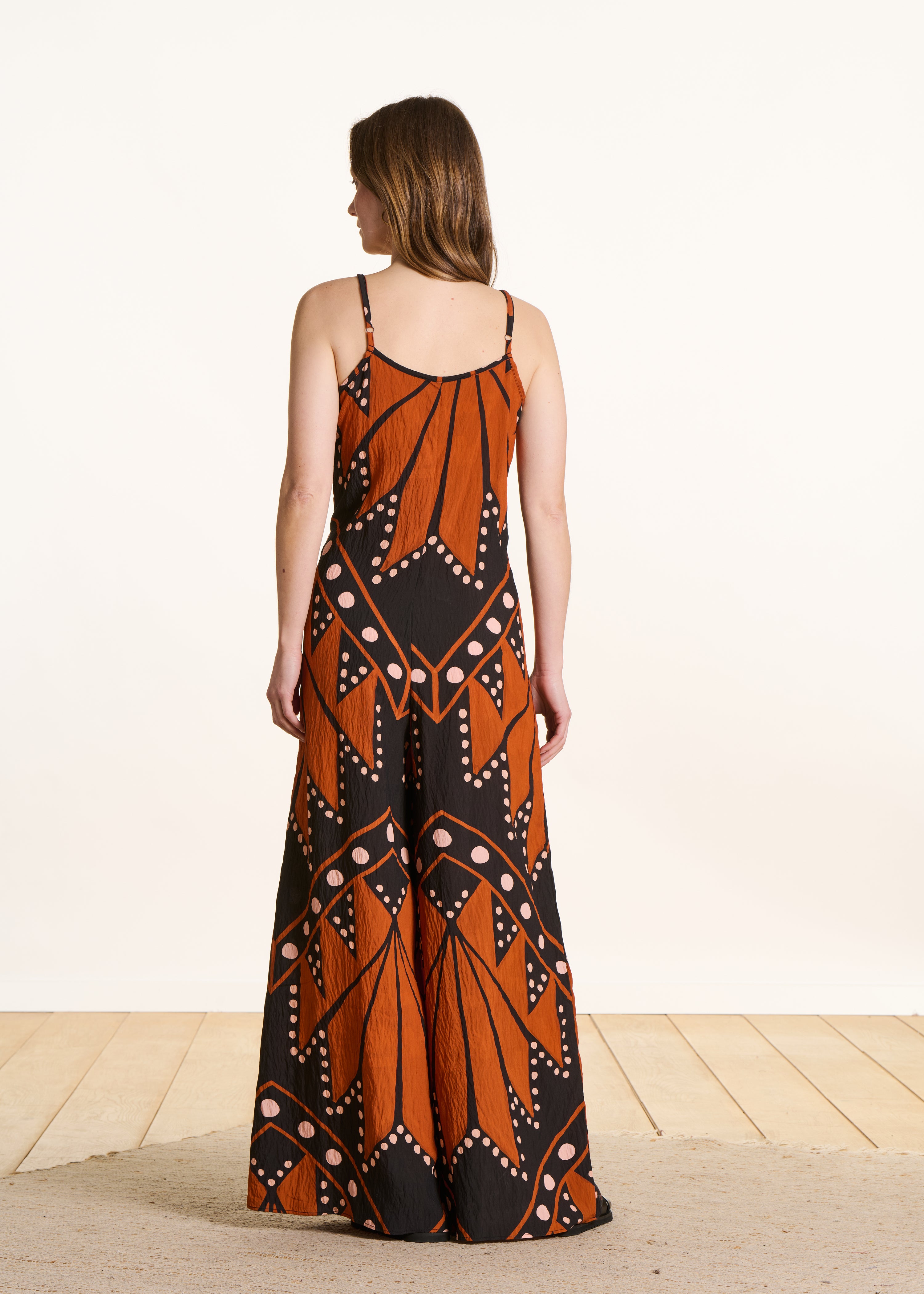 Loose long jumpsuit with straps, black and orange print