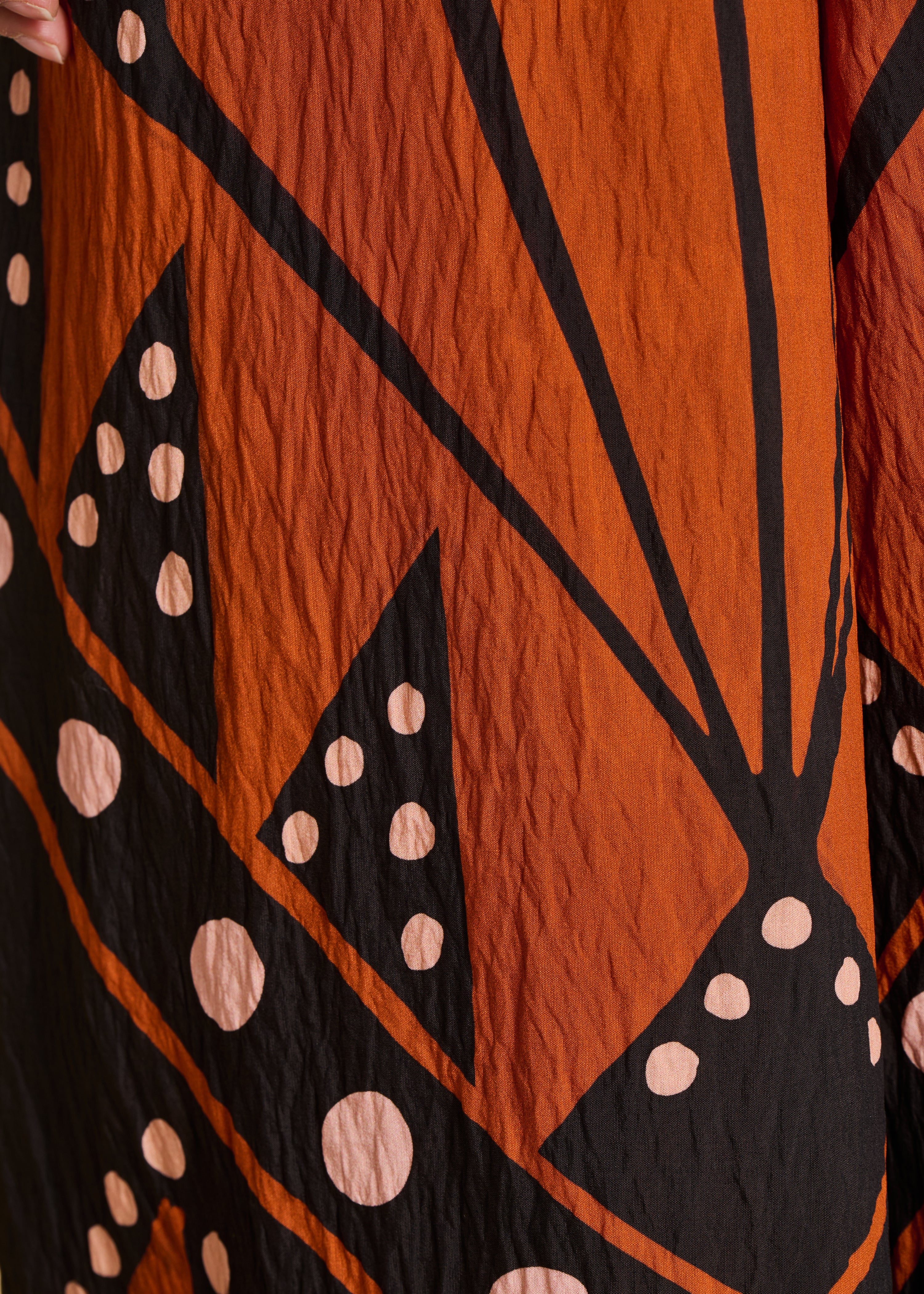 Loose long jumpsuit with straps, black and orange print