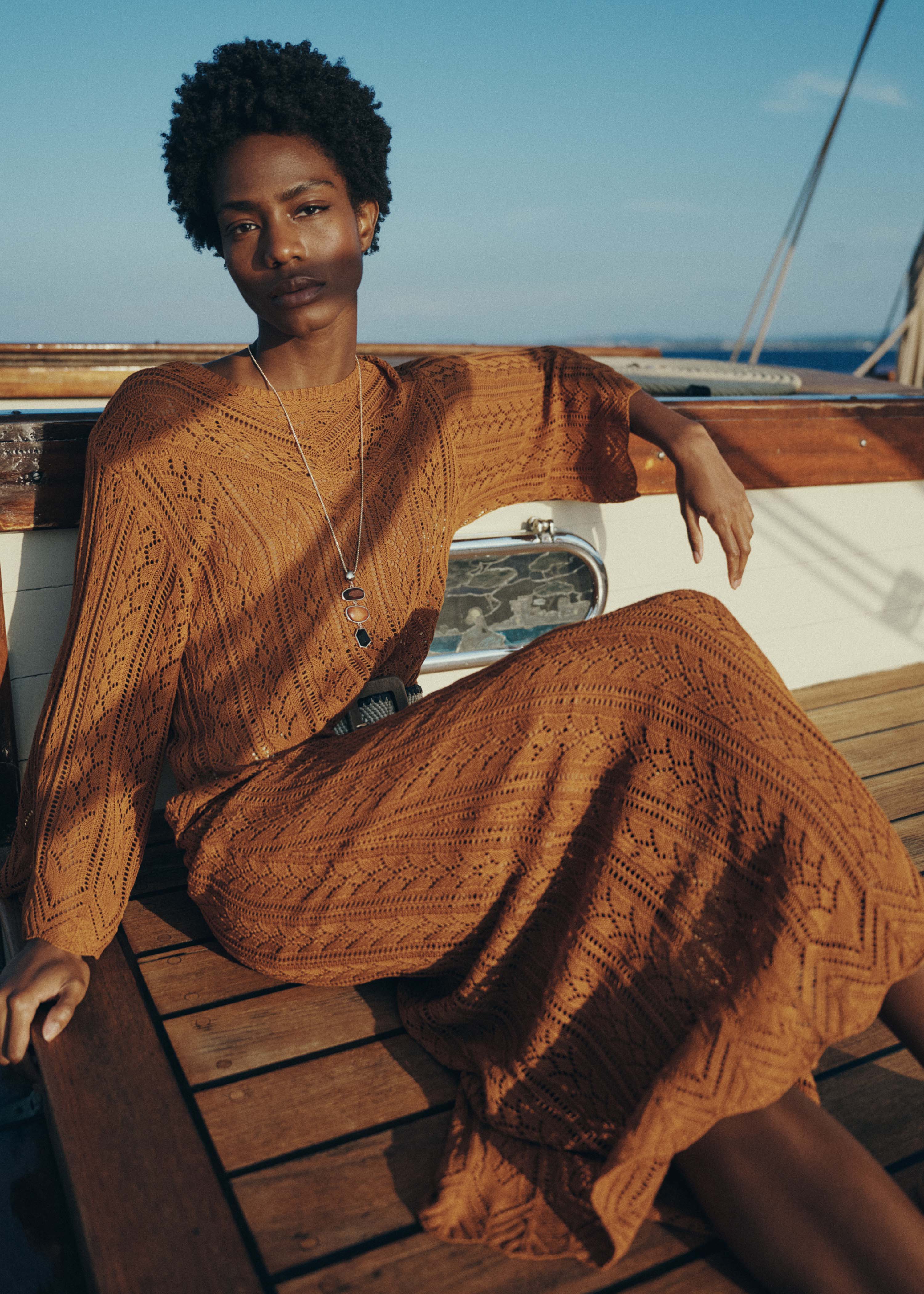 Short brown sweater in fine openwork knit