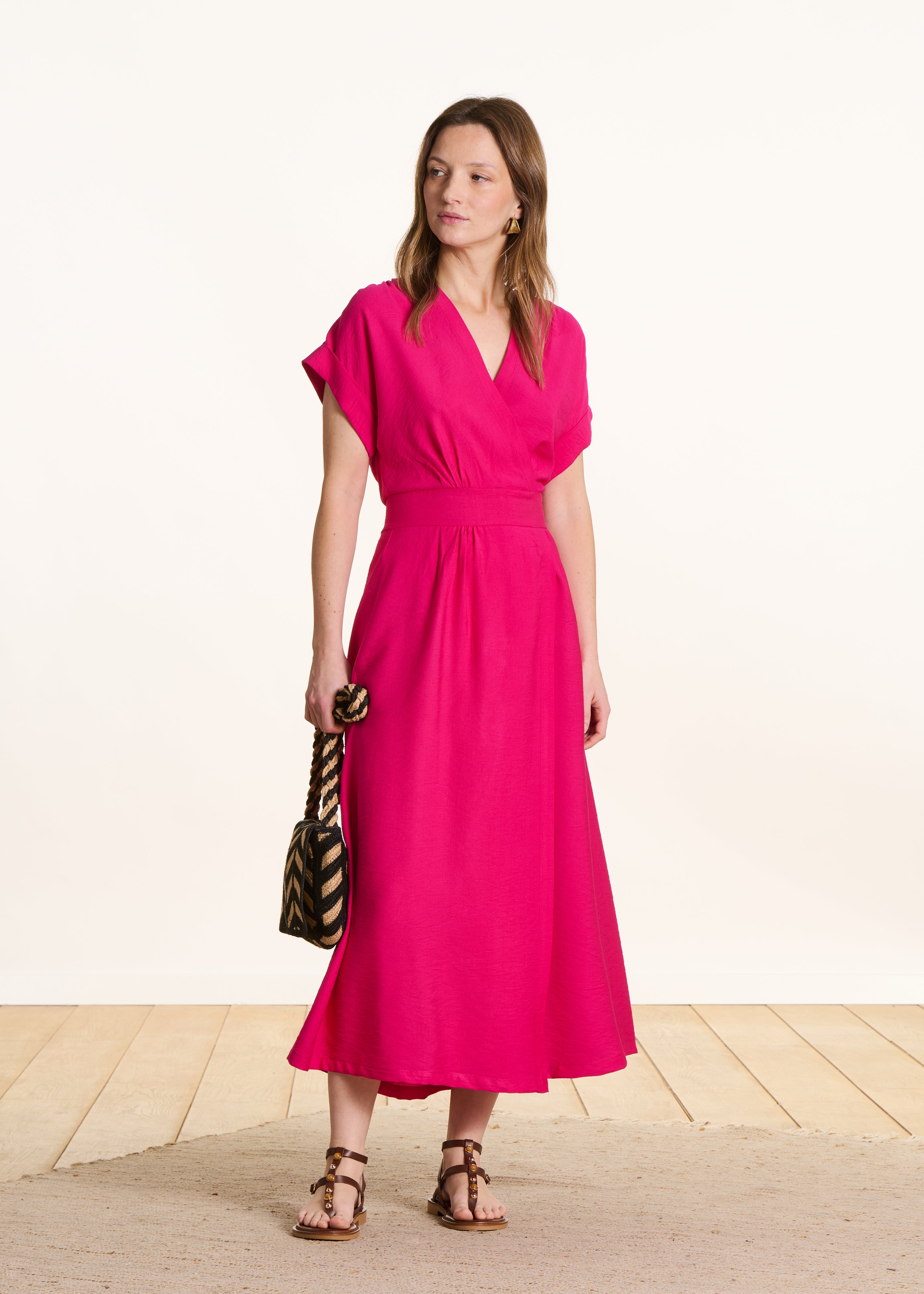 Fitted long dress in fuchsia pink with wrap front