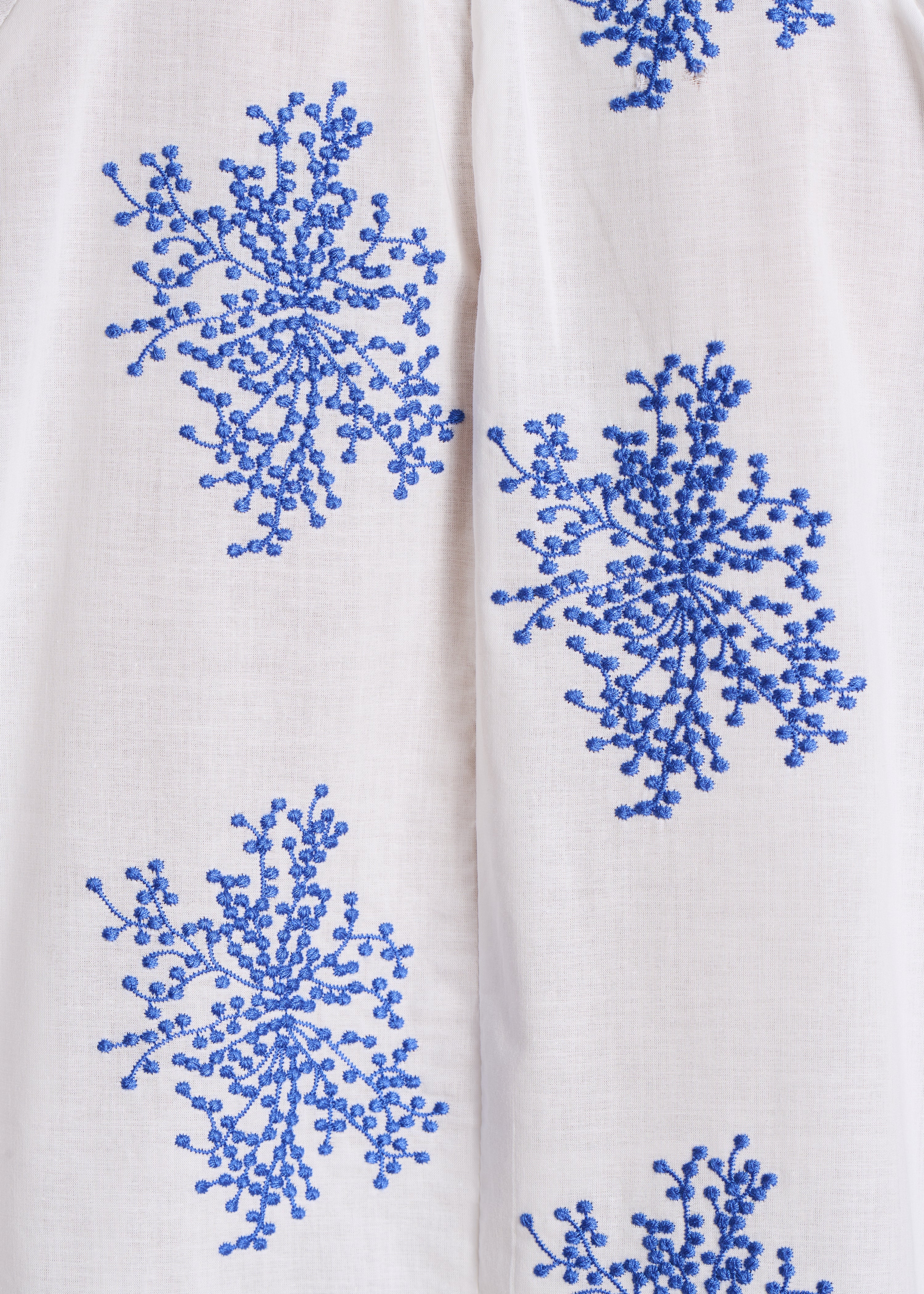 Blouse oversize blanche à broderies bleues manches longues