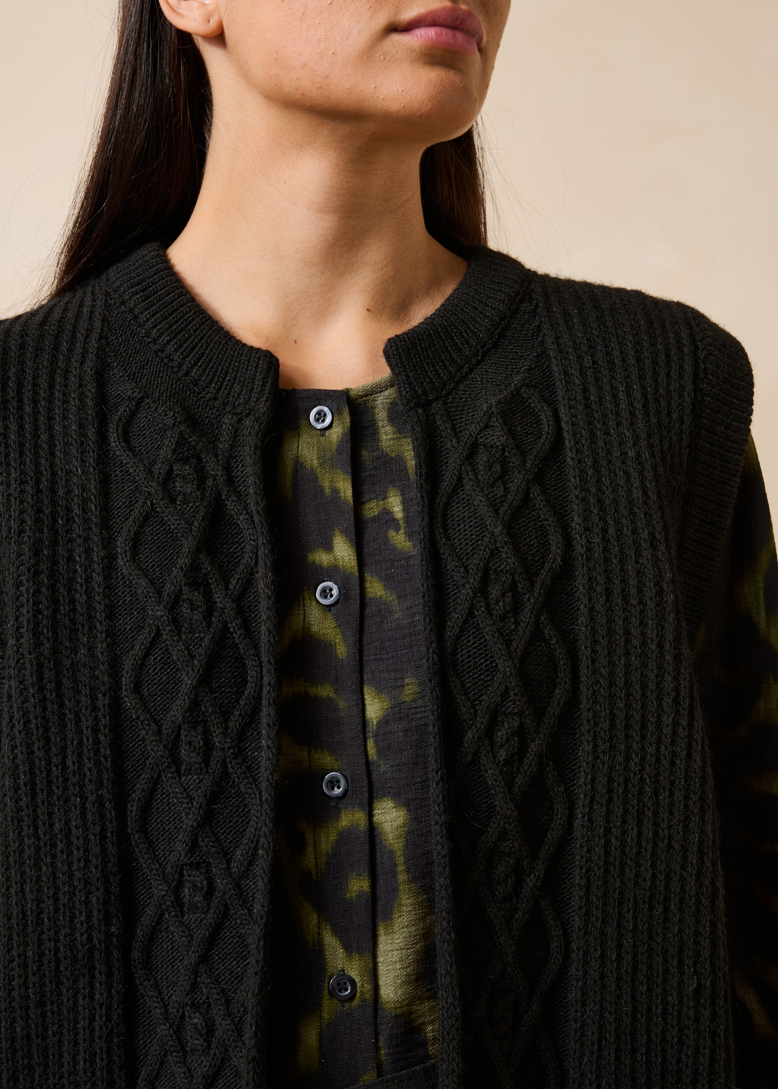 Black sleeveless cardigan with round neckline