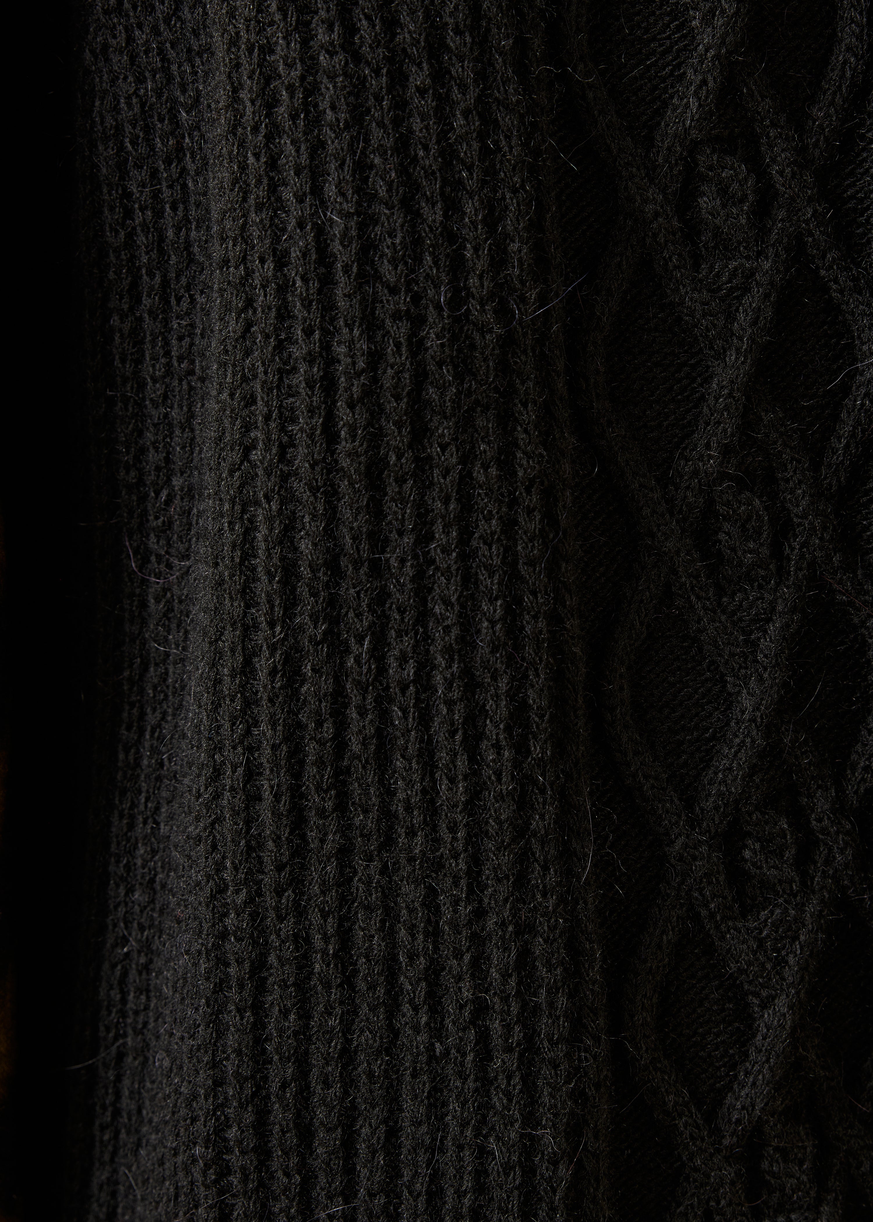 Black sleeveless cardigan with round neckline