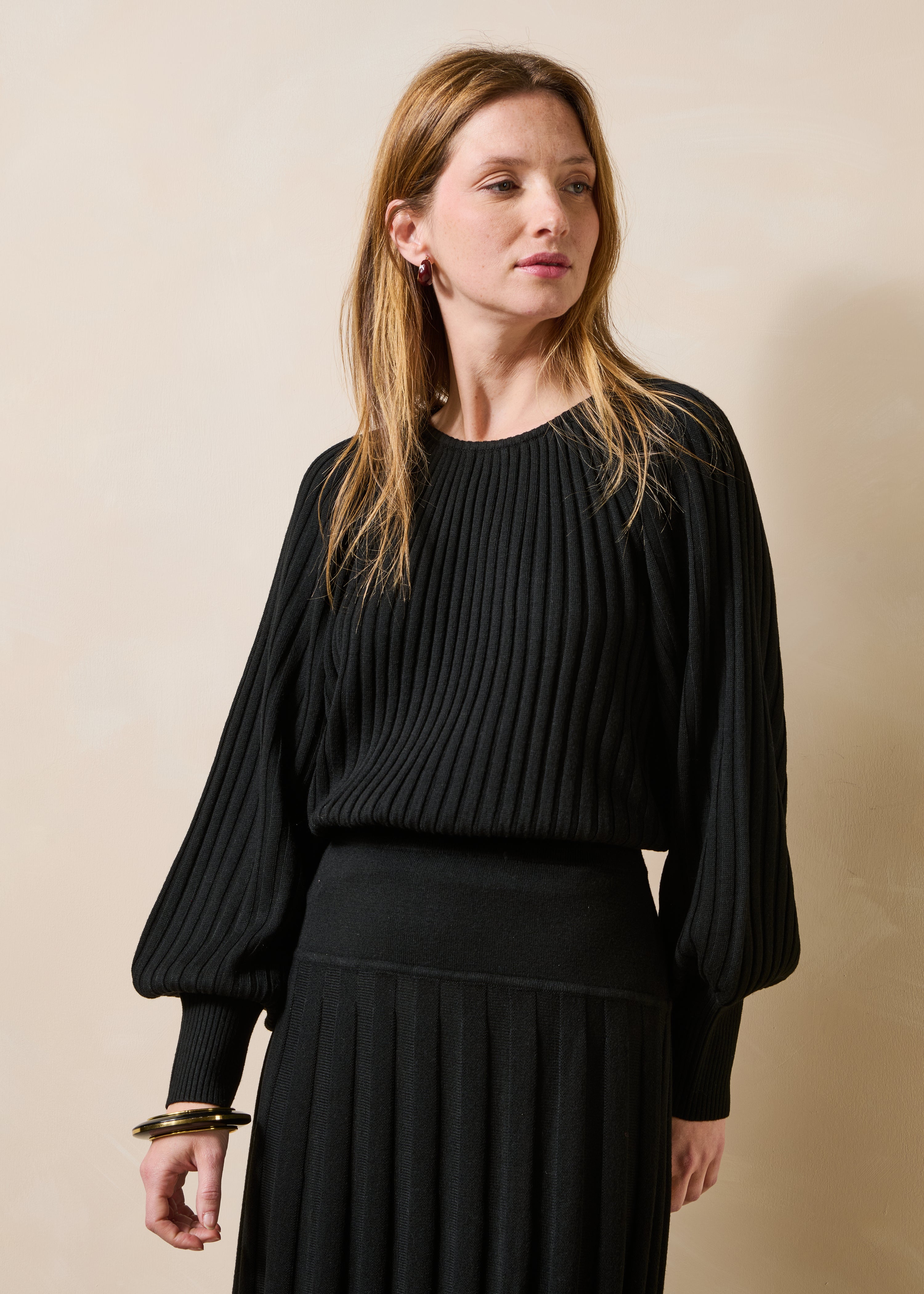 Black pleated knit long sleeve sweater
