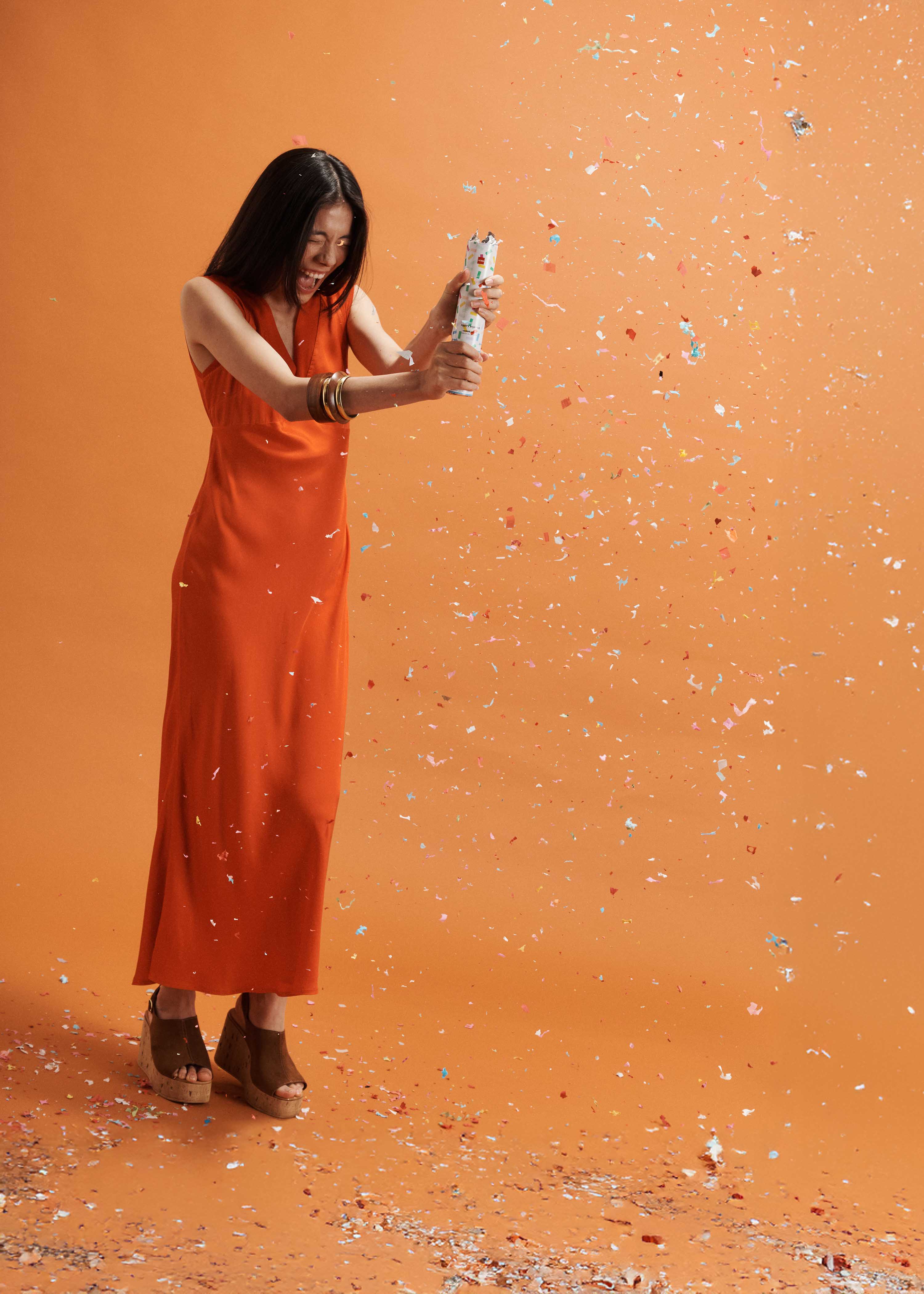 Flowing long orange satin sleeveless dress