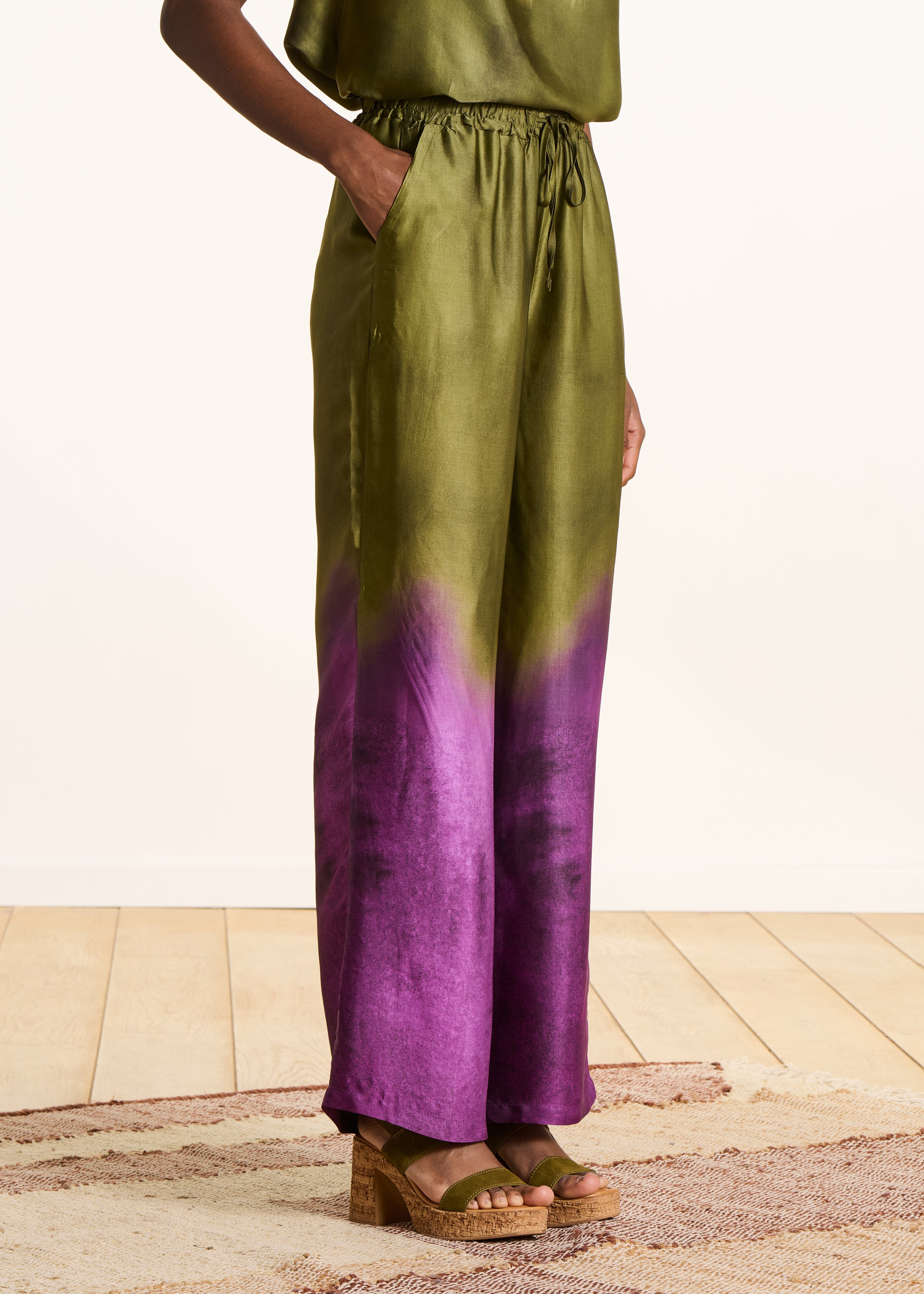 Wide green satin pants with tie-dye print