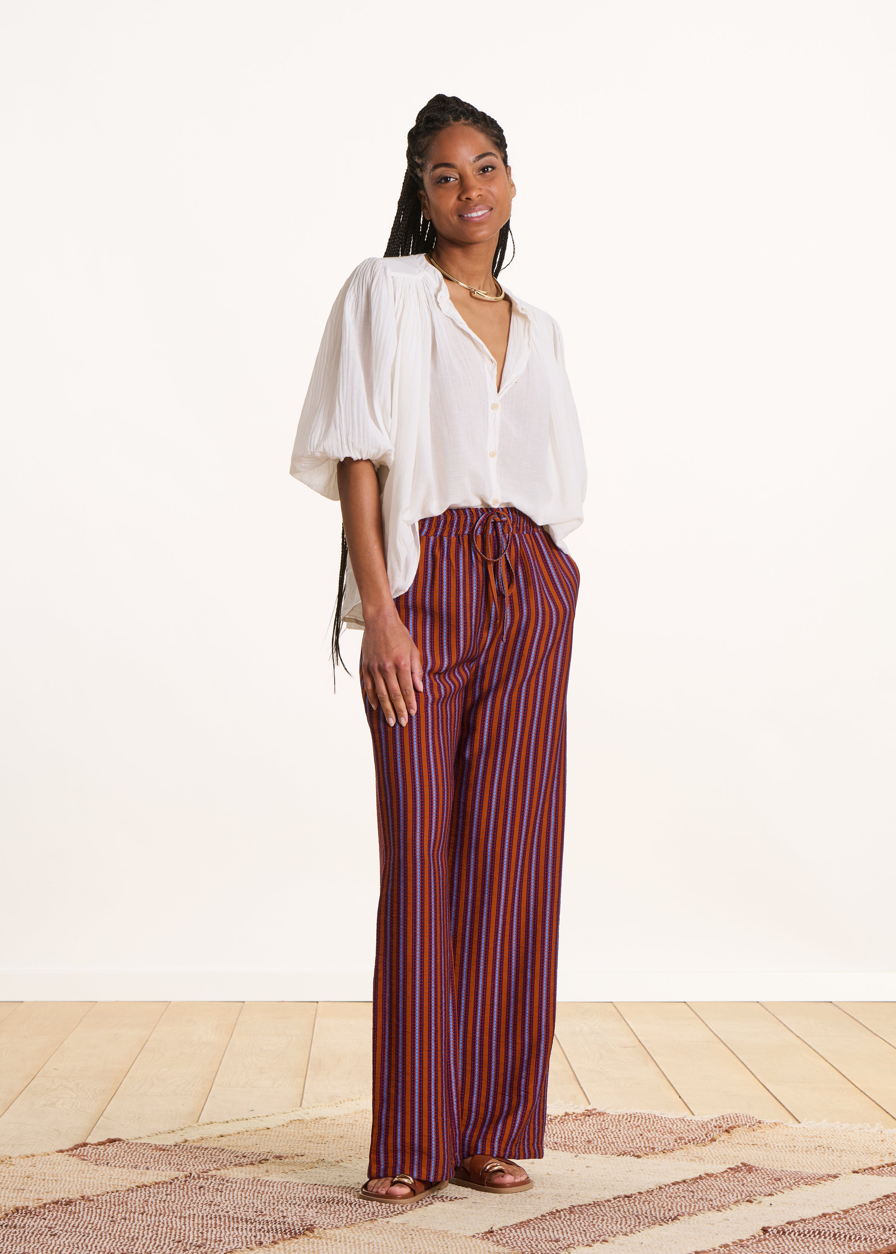 Wide purple and orange striped trousers