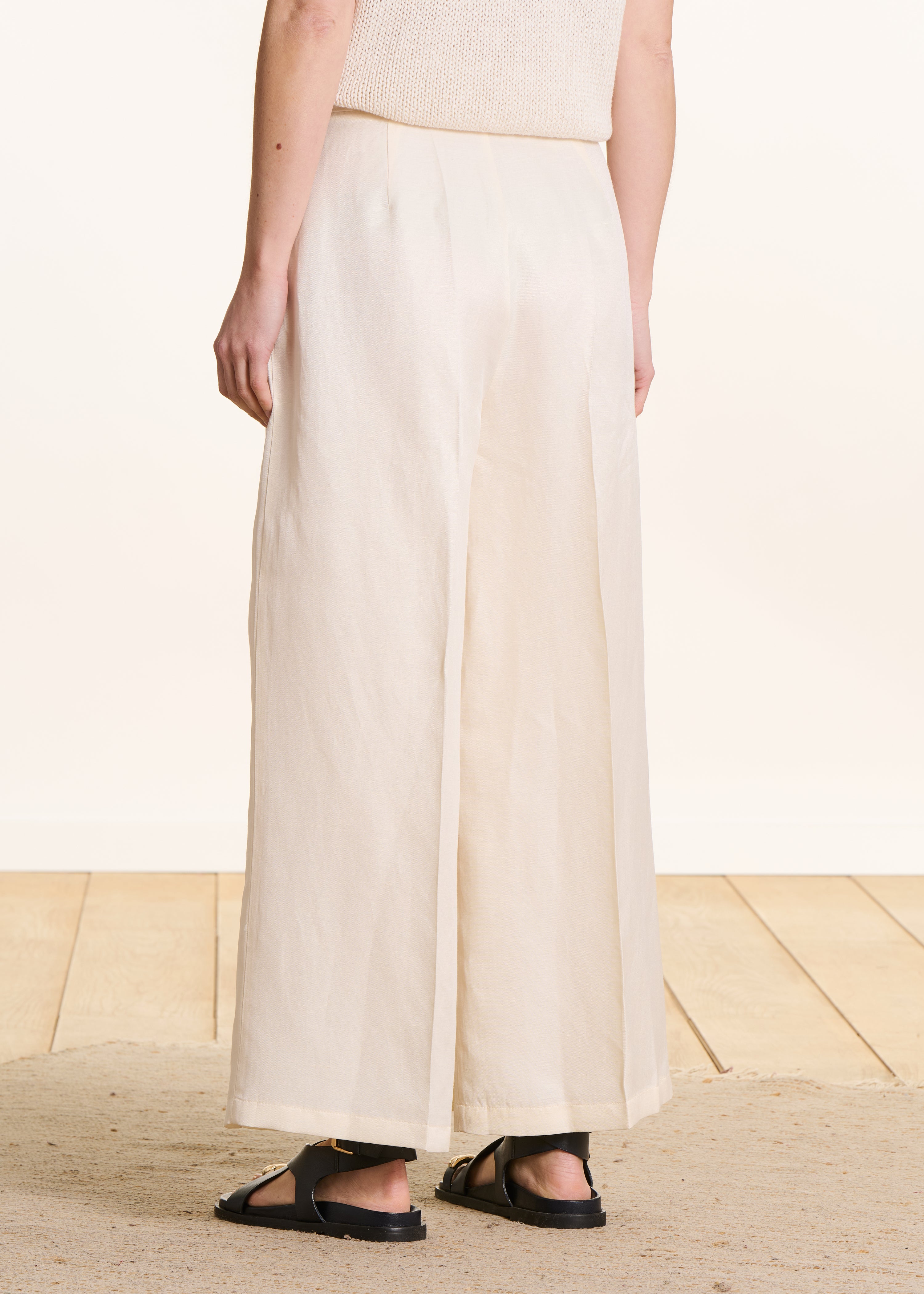 High-waisted 7/8-length ivory pants with side slit