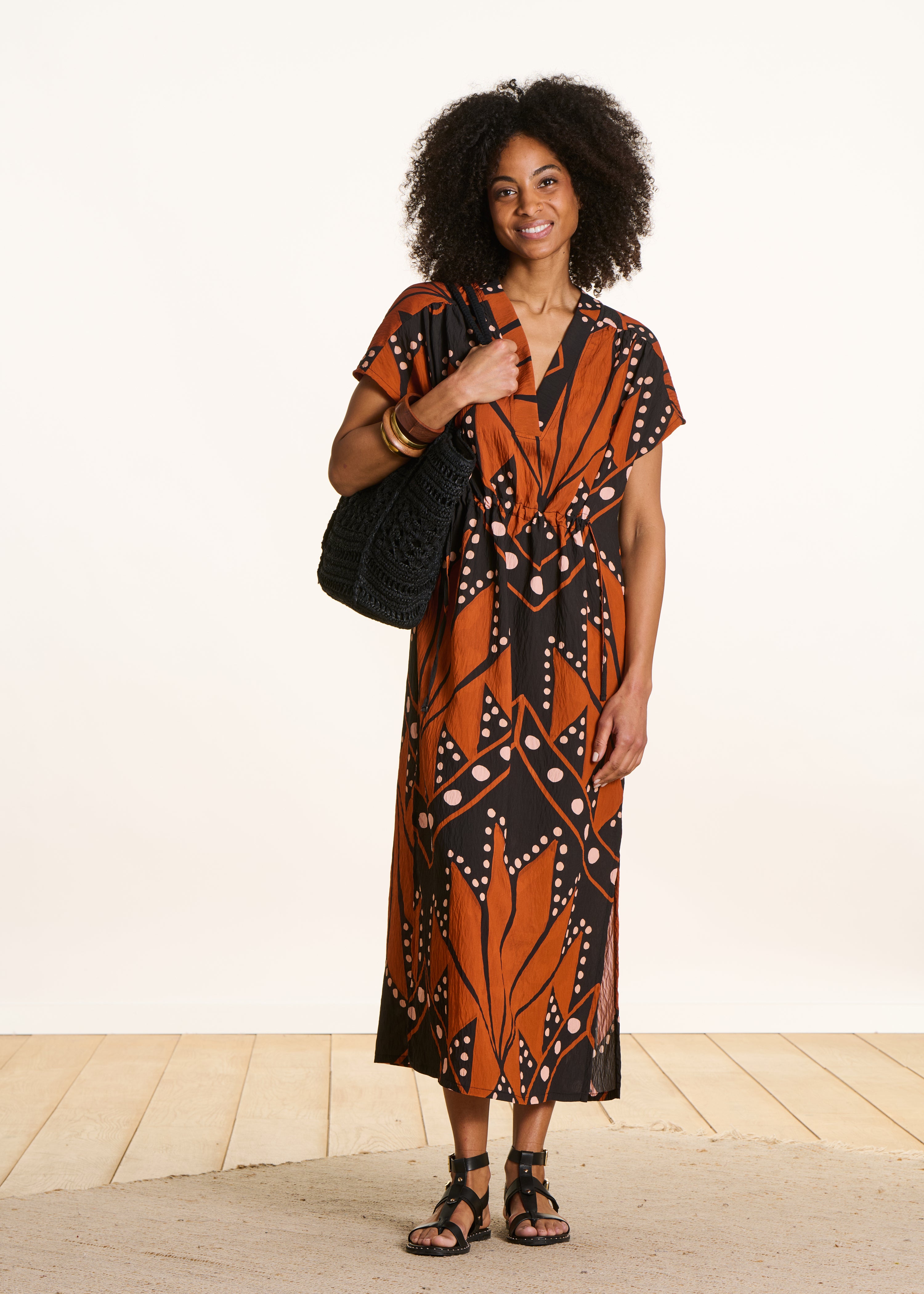 Long dress with V-neck and black and orange print