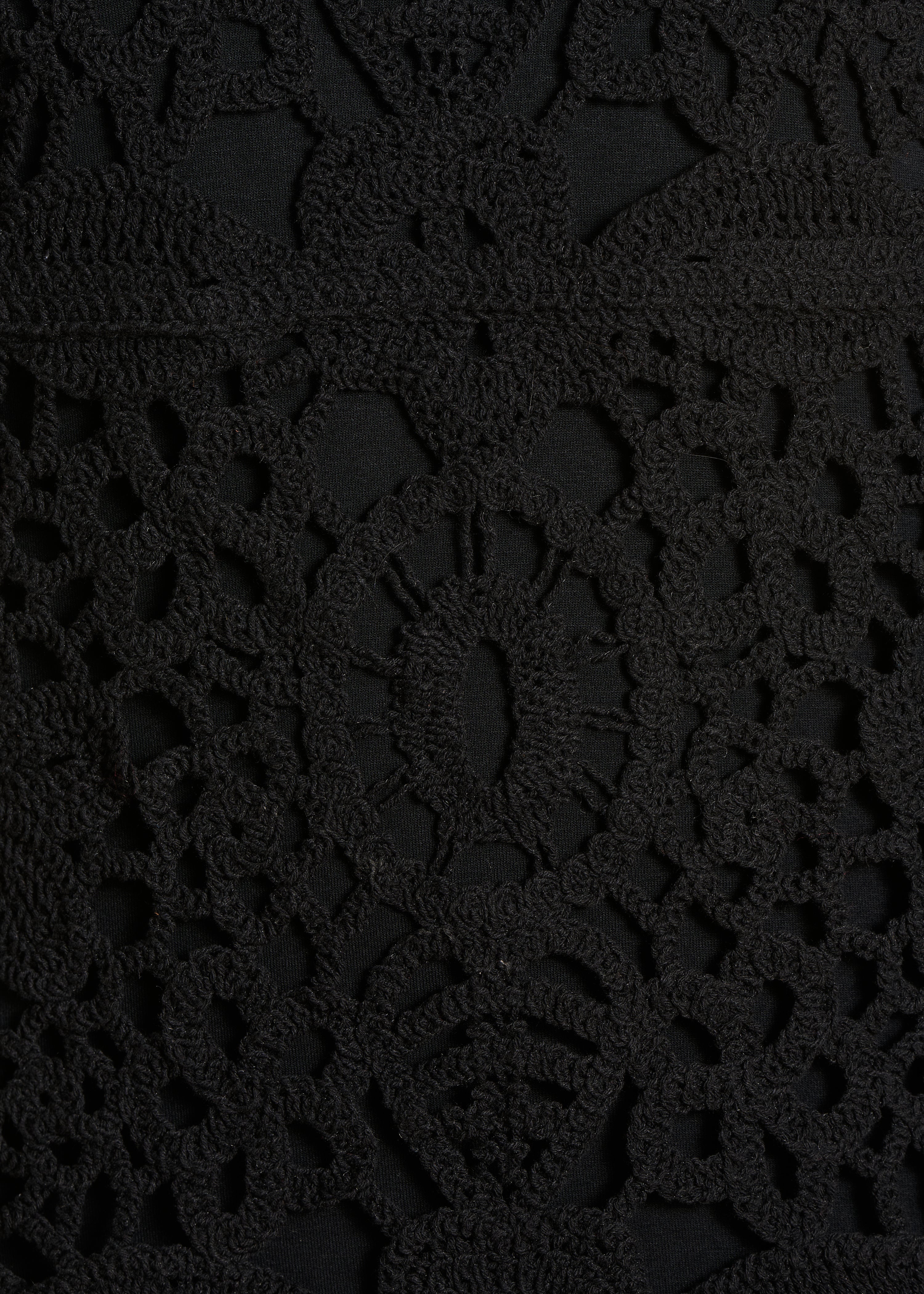 Short black dress in crochet knit