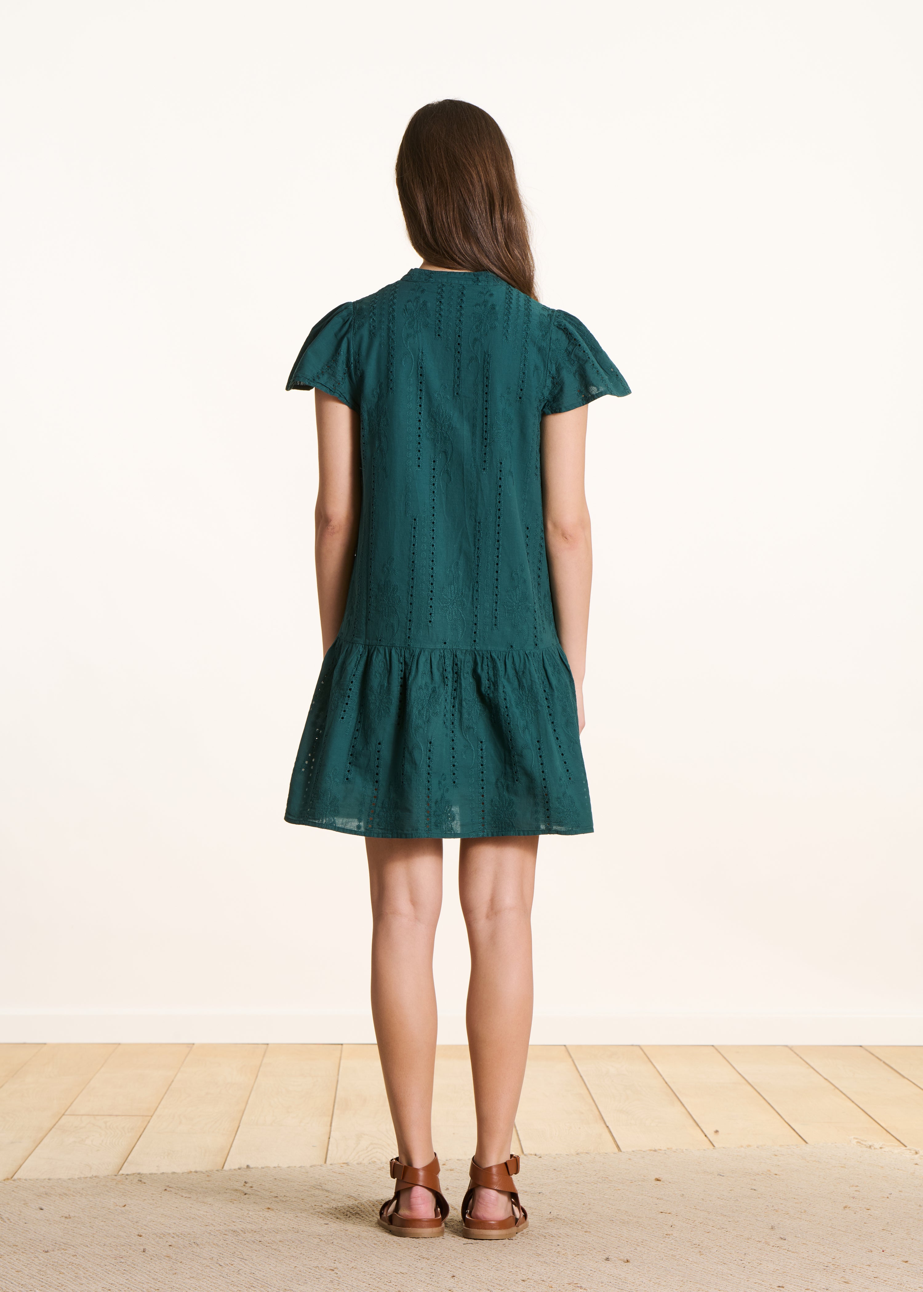 Dark green short dress in eyelet embroidery with ruffle