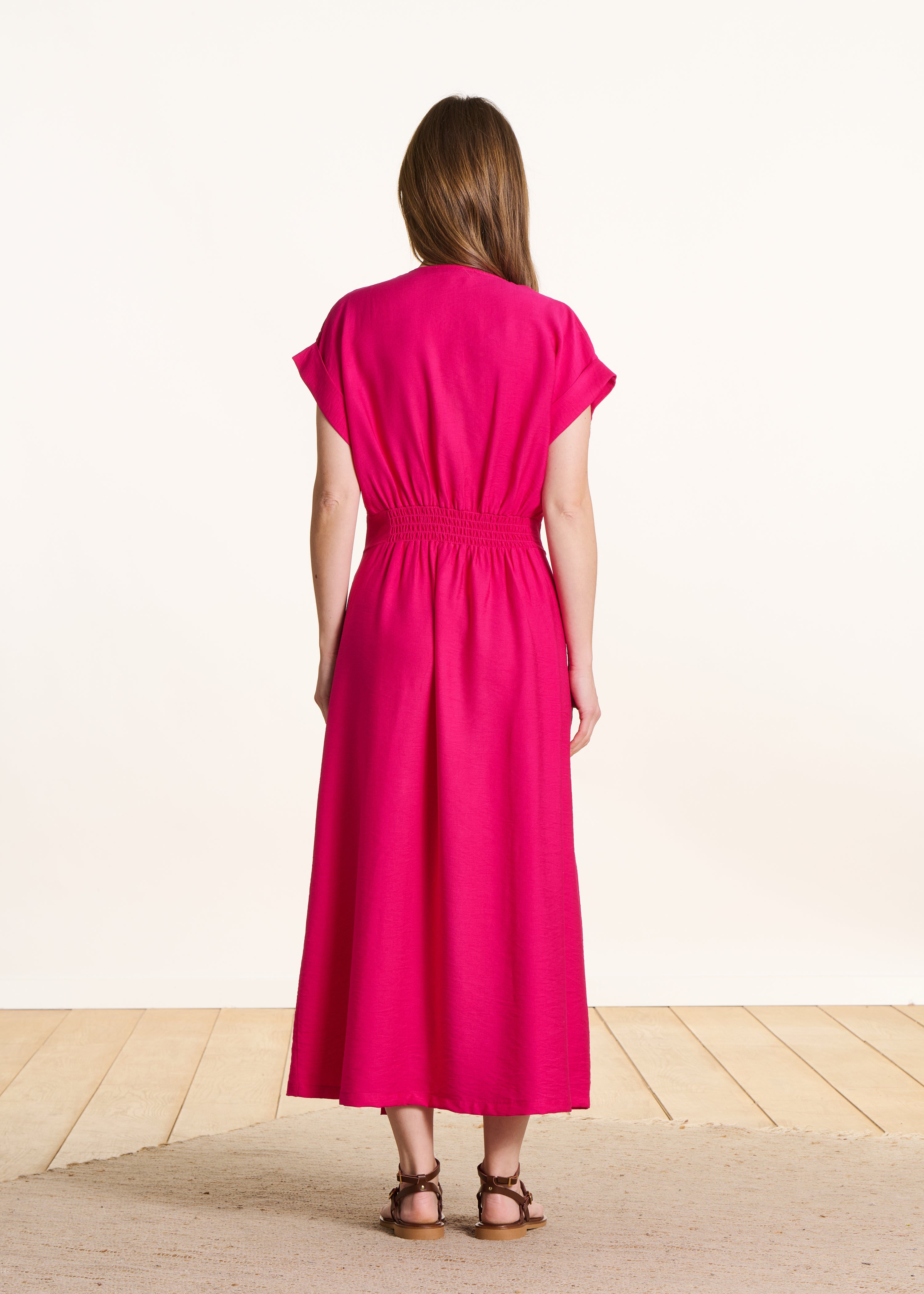 Fitted long dress in fuchsia pink with wrap front