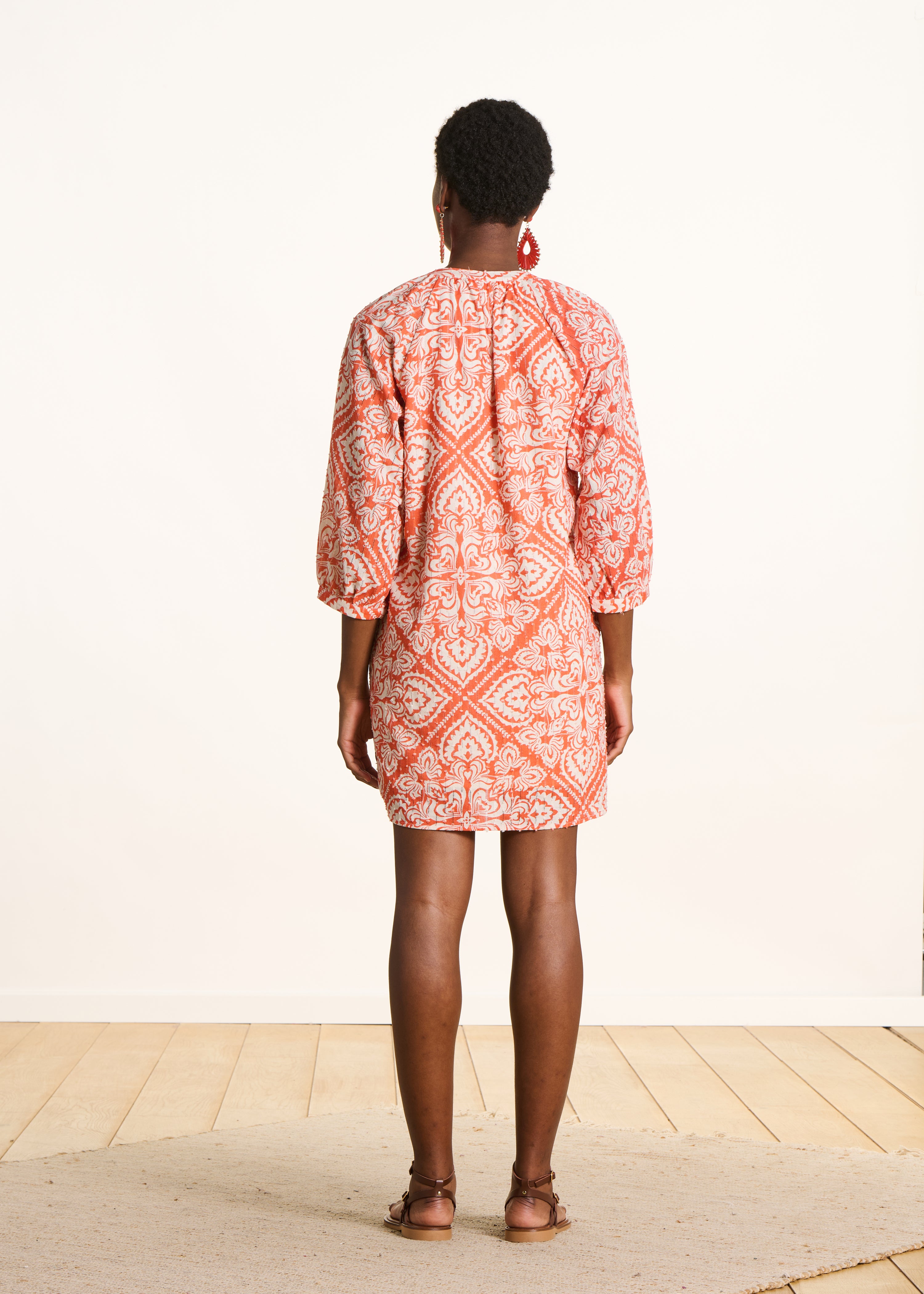 Orange short openwork dress with floral print
