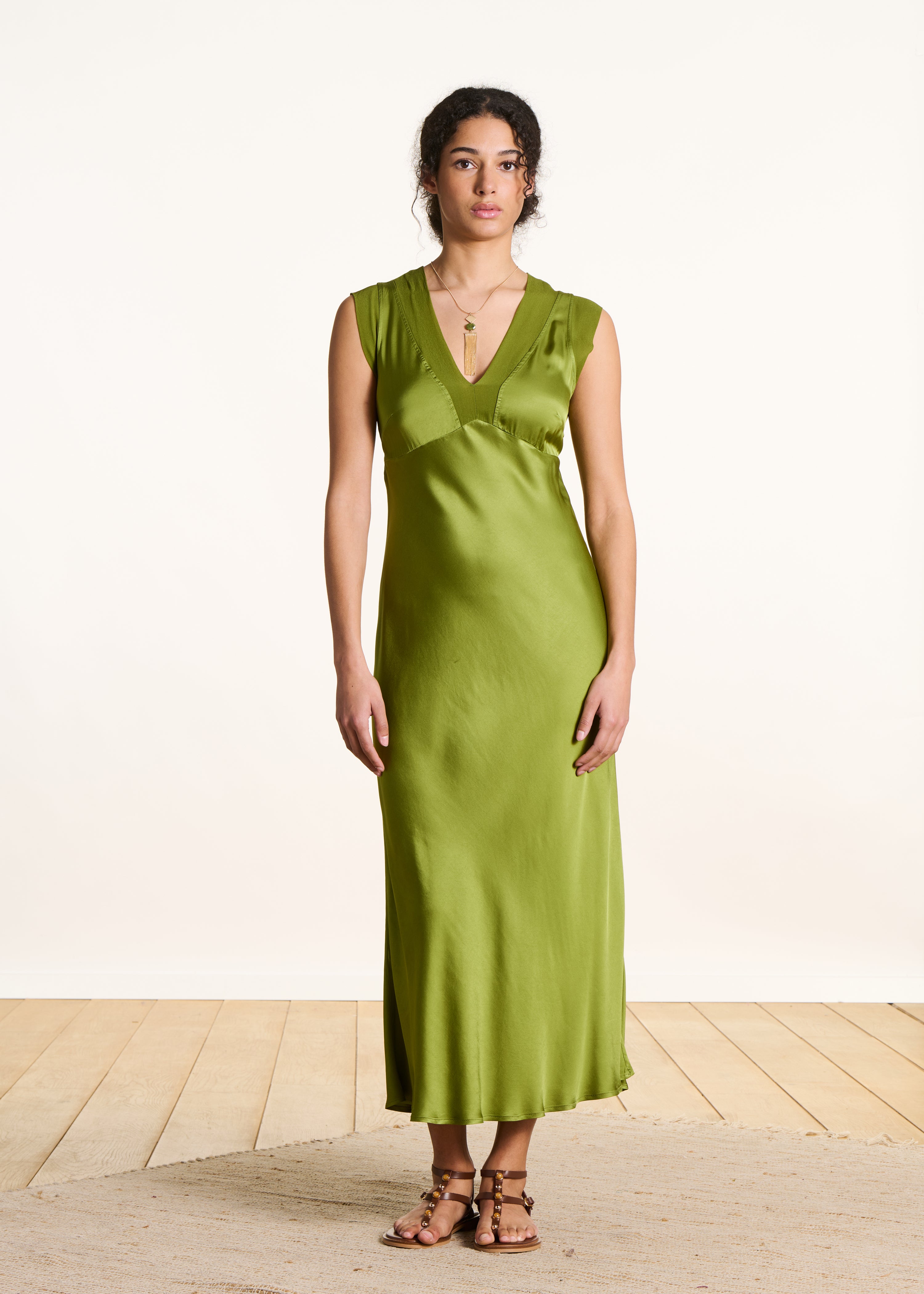 Flowing long green satin sleeveless dress