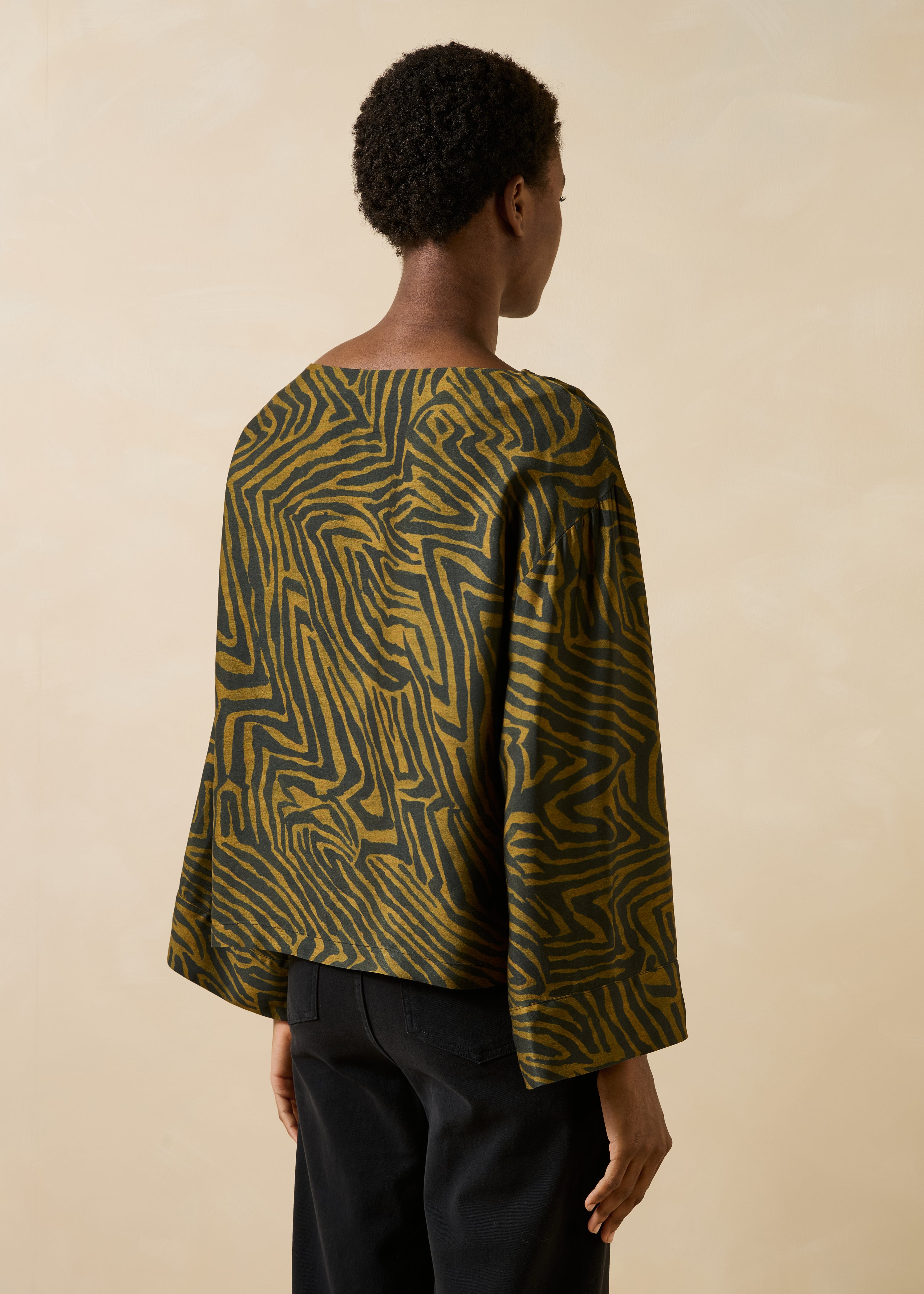 Loose black and ochre fluid top with long printed sleeves